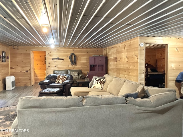 living room with wood walls and wood finished floors