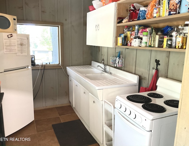 kitchen featuring white appliances, dark tile patterned flooring, white cabinetry, light countertops, and open shelves