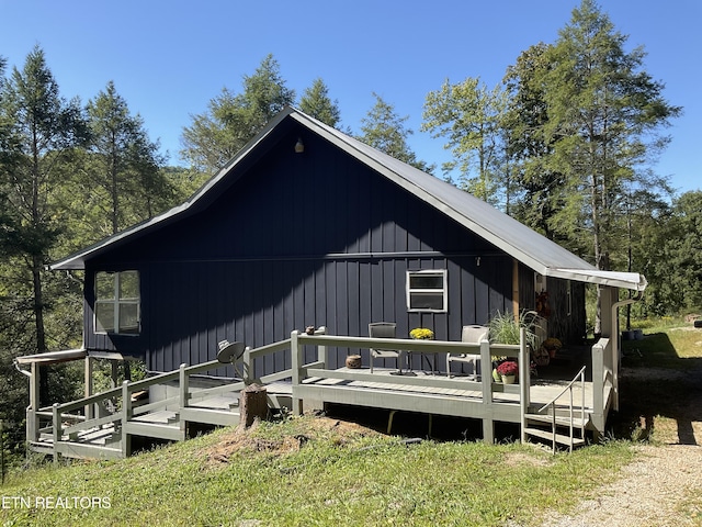 back of house with a deck and board and batten siding