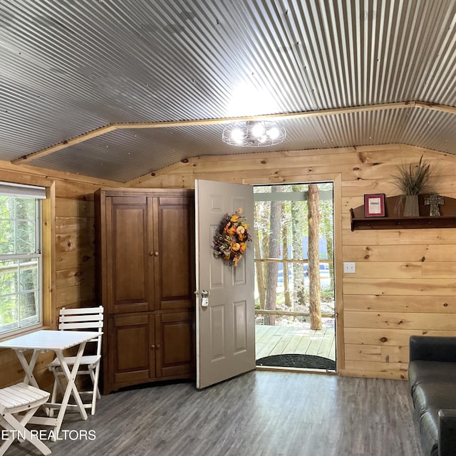 entryway with lofted ceiling, wood walls, wood finished floors, and wood ceiling