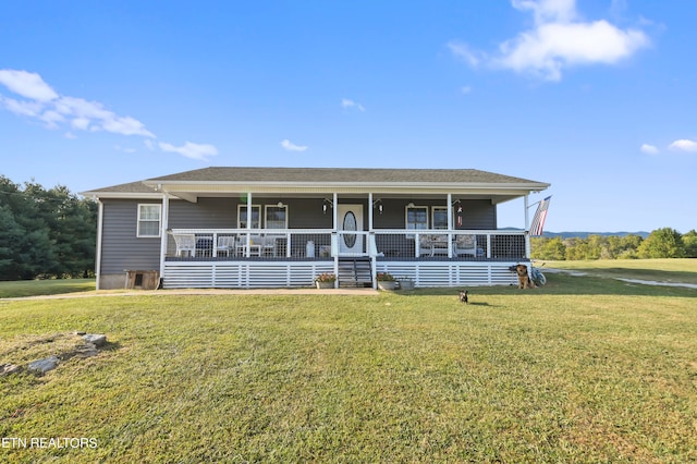 view of front of property featuring covered porch and a front yard