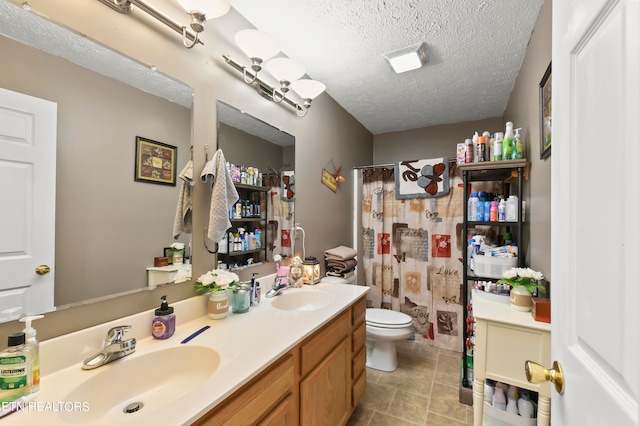 bathroom with a textured ceiling, vanity, toilet, and a shower with shower curtain