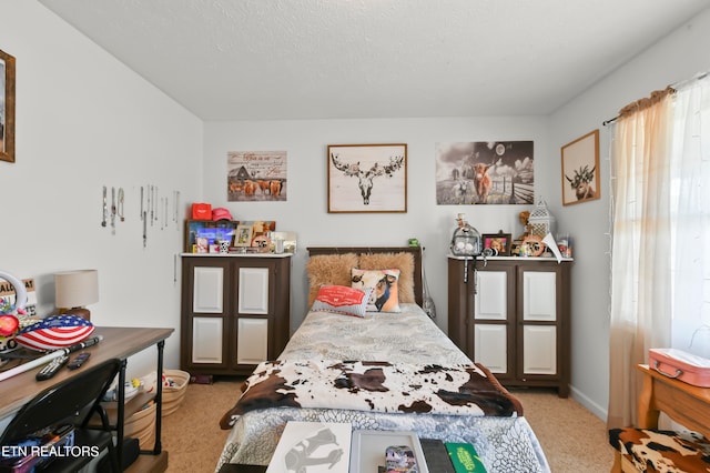 bedroom featuring a textured ceiling and light colored carpet