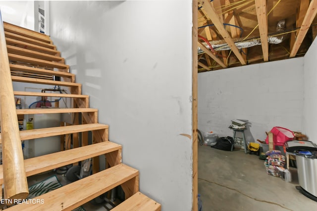 staircase with concrete floors