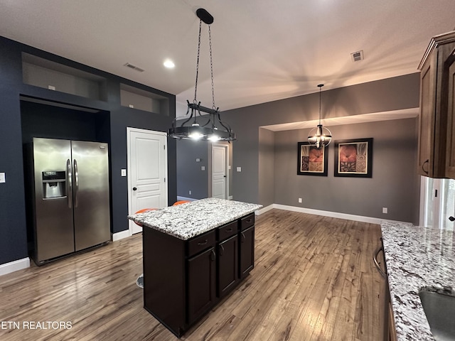 kitchen featuring visible vents, light wood-style flooring, baseboards, and stainless steel fridge with ice dispenser