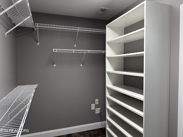 spacious closet featuring visible vents