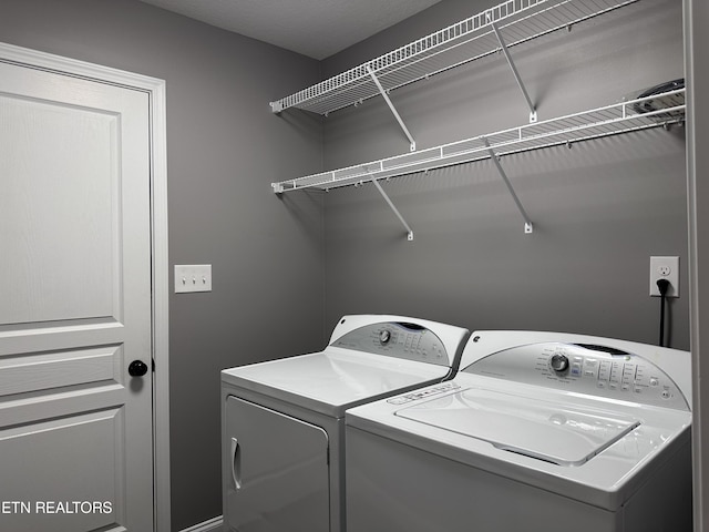 washroom featuring separate washer and dryer and laundry area