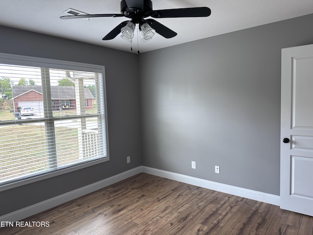 spare room with ceiling fan, a textured ceiling, baseboards, and wood finished floors