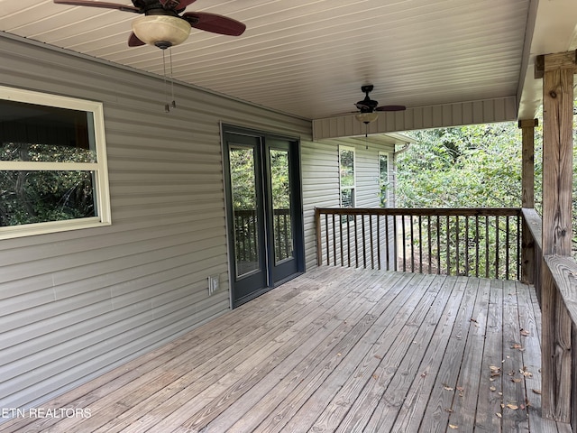 wooden terrace featuring a ceiling fan