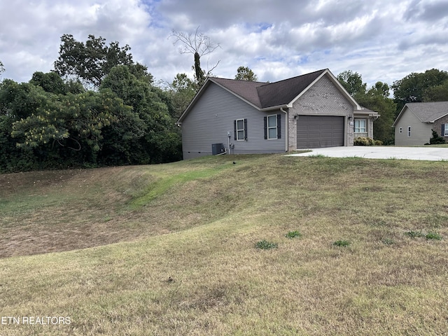 view of front facade featuring central AC unit, an attached garage, a front lawn, concrete driveway, and brick siding