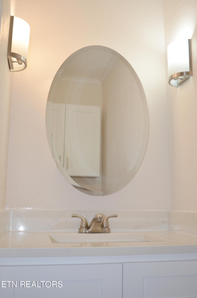 bathroom featuring ornamental molding and vanity