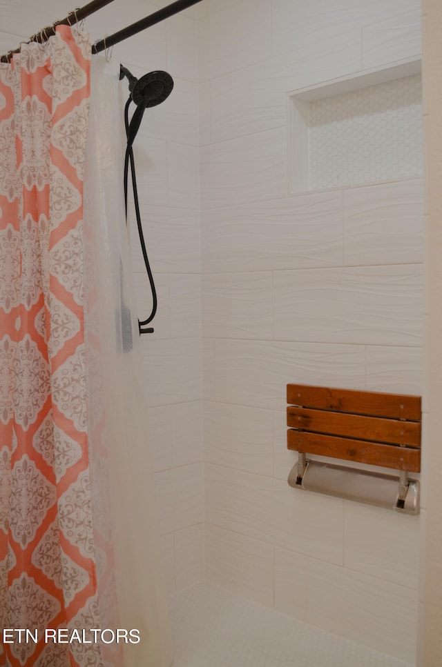 interior details featuring a shower with shower curtain