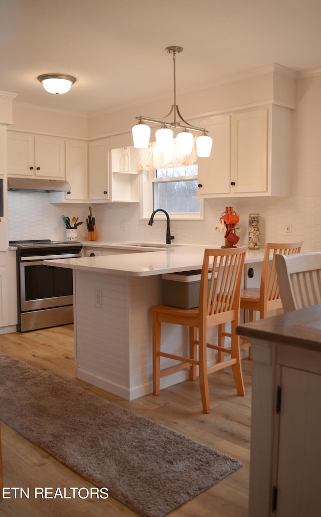 kitchen with stainless steel electric range oven, light hardwood / wood-style floors, crown molding, sink, and white cabinetry