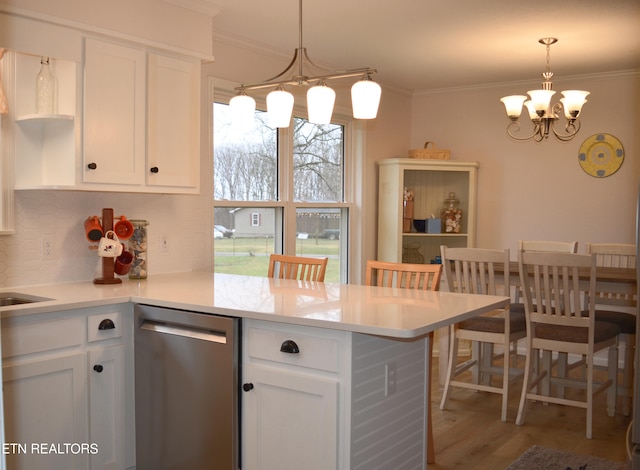 kitchen with dishwasher, white cabinetry, and kitchen peninsula