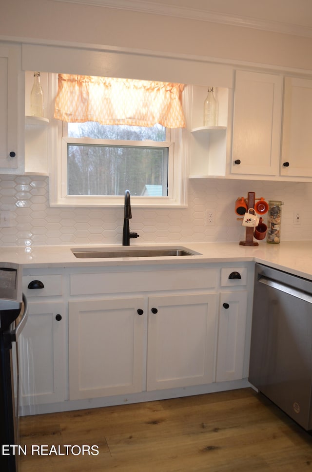 kitchen featuring a wealth of natural light, stainless steel appliances, sink, and white cabinets