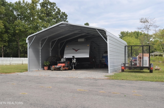 view of outdoor structure with a yard and a carport