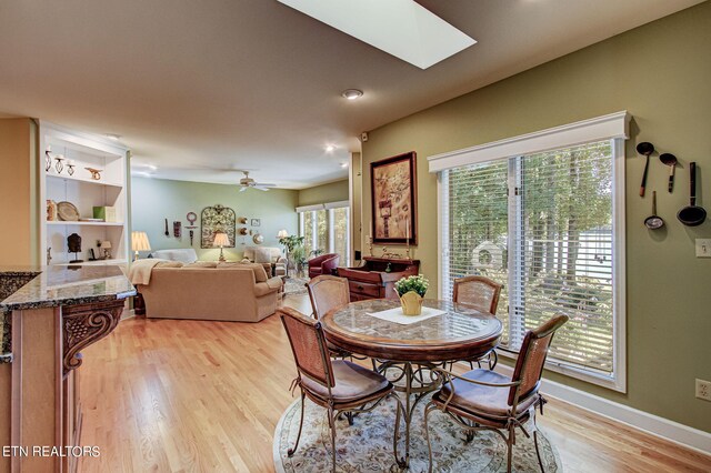 108 Waynoka Ln, Loudon, TN 37774 - dining area featuring light wood finished floors, baseboards, a skylight, and a ceiling fan