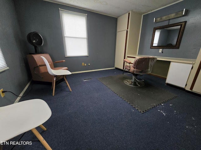 unfurnished room featuring a textured ceiling and dark carpet