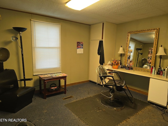 interior space featuring built in desk and a textured ceiling