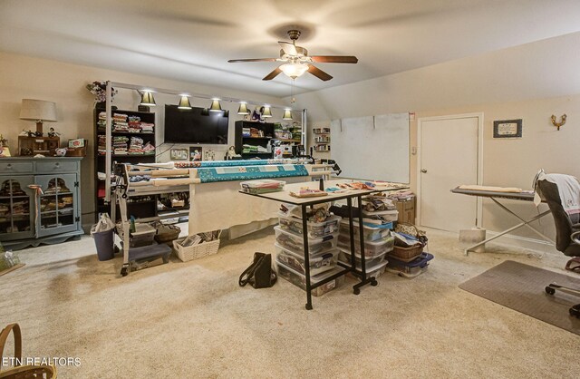 carpeted dining space with lofted ceiling and ceiling fan