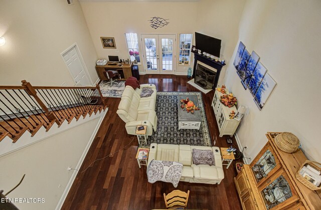 living room with dark hardwood / wood-style floors and french doors