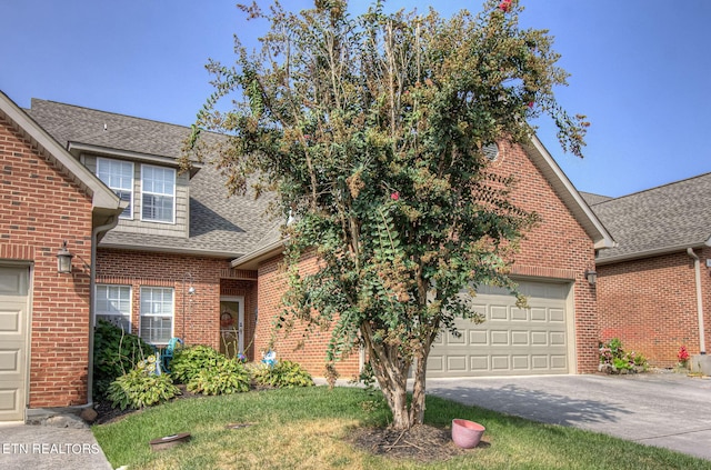 view of front of house featuring a garage and a front yard