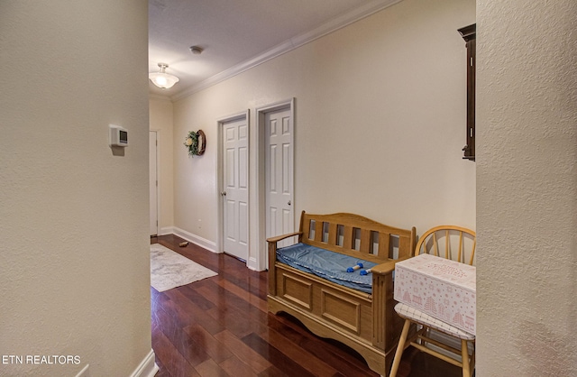 corridor featuring dark hardwood / wood-style floors and crown molding