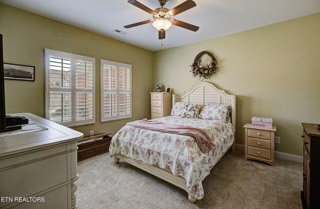 bedroom with light carpet and ceiling fan