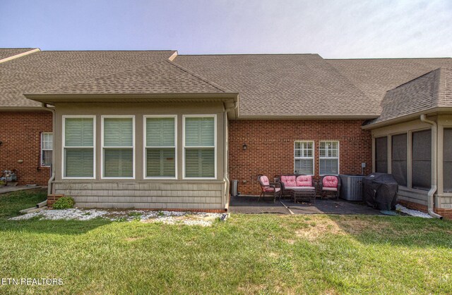 rear view of property with an outdoor hangout area, a yard, and a patio