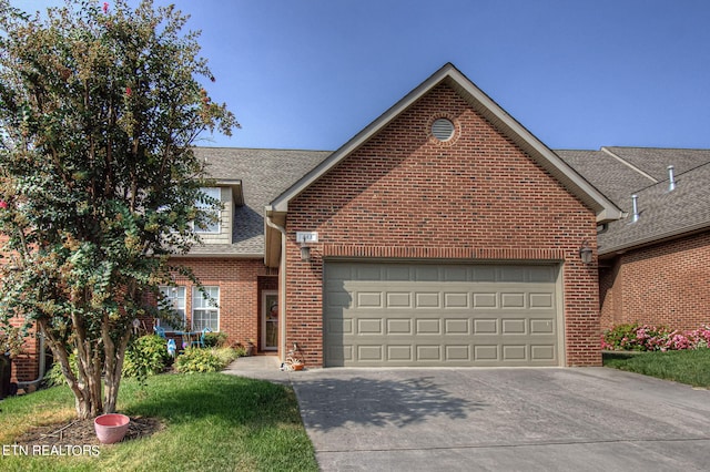 view of front of house with a garage, brick siding, concrete driveway, and a shingled roof