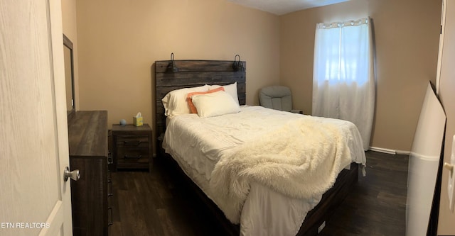 bedroom with dark wood-type flooring