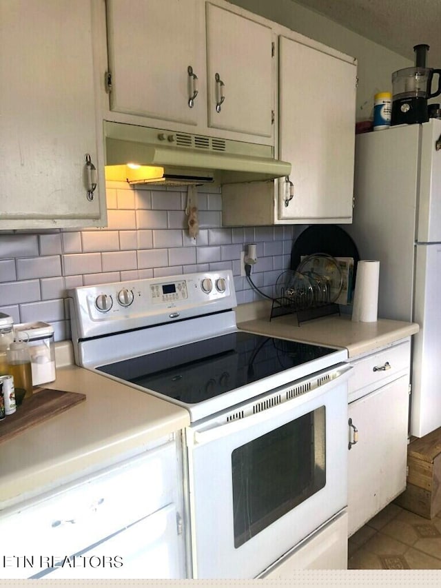 kitchen with tile patterned floors, electric stove, backsplash, and white cabinetry