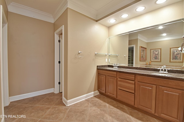 bathroom with tile patterned flooring, crown molding, and vanity