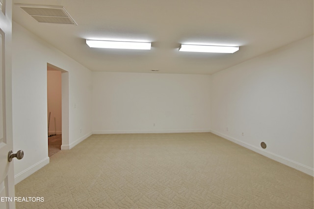 unfurnished room with light colored carpet