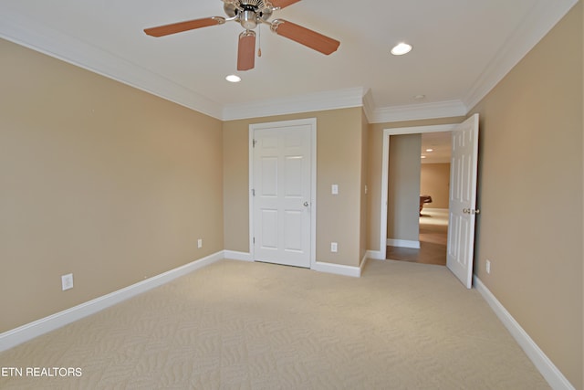 unfurnished bedroom featuring ceiling fan, light carpet, and ornamental molding