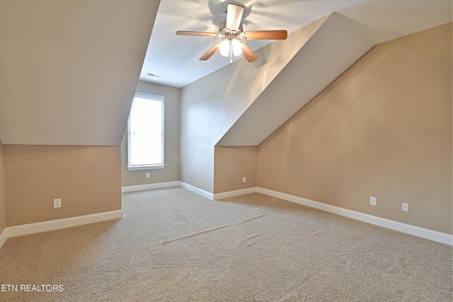 bonus room featuring ceiling fan, light carpet, and vaulted ceiling