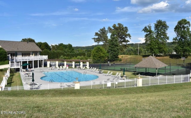 view of pool with a lawn and a patio