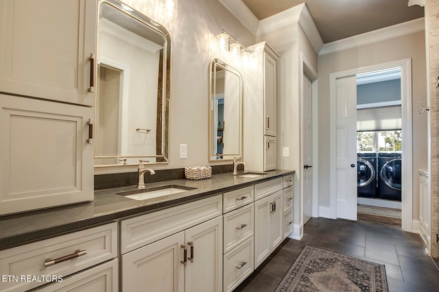 bathroom with crown molding, vanity, washer and clothes dryer, and tile patterned floors