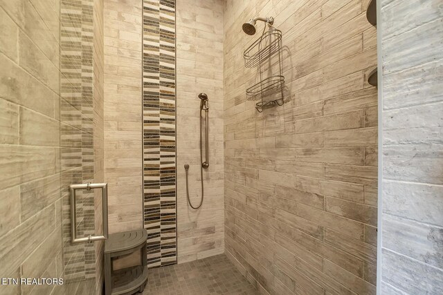 bathroom featuring a shower with door