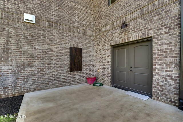 property entrance with a patio