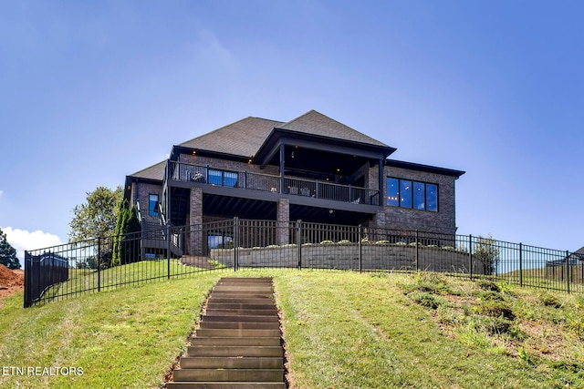 rear view of house featuring a yard