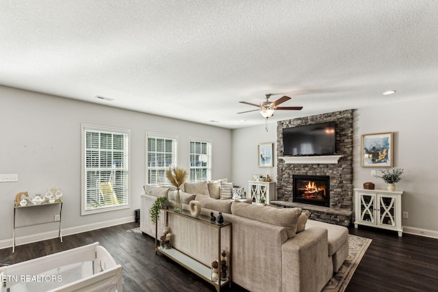 living room with a fireplace, a textured ceiling, and dark hardwood / wood-style flooring