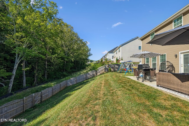 view of yard with outdoor lounge area, a playground, and a patio area