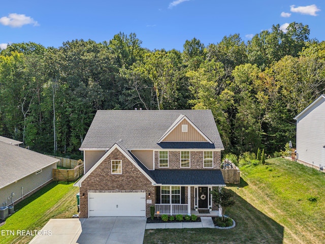 view of front facade featuring covered porch, a garage, and a front lawn