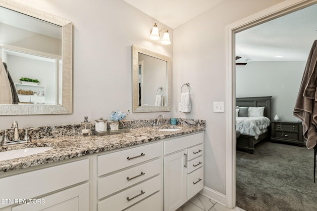 bathroom with ceiling fan, vanity, and lofted ceiling