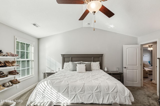 bedroom with ceiling fan, carpet, and vaulted ceiling