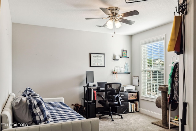 carpeted office with ceiling fan