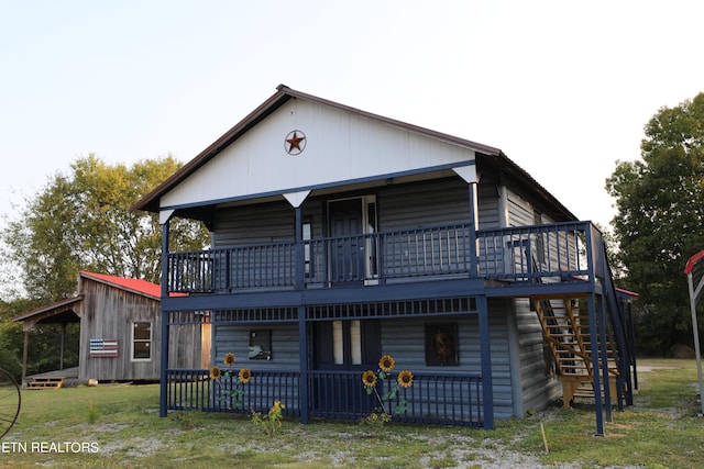 back of property featuring a yard and a deck