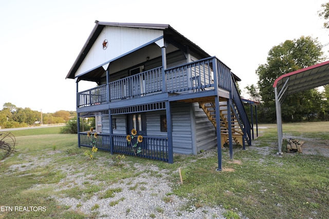 rear view of house featuring a lawn and a wooden deck