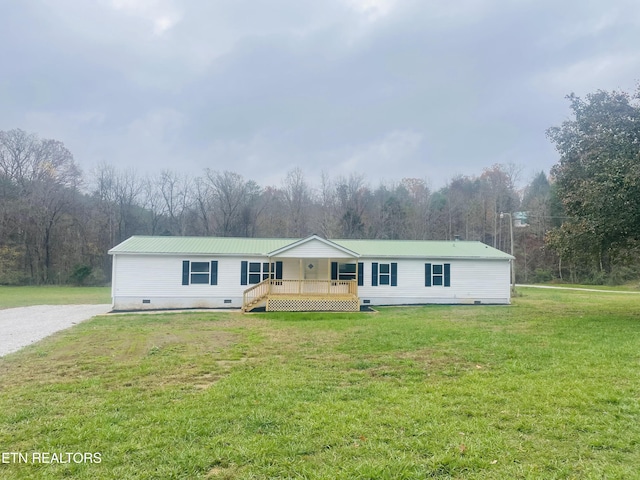 231 Baker Farm Rd, Tellico Plains, TN 37385 - manufactured / mobile home with crawl space, a front lawn, metal roof, a wooden deck, and a wooded view
